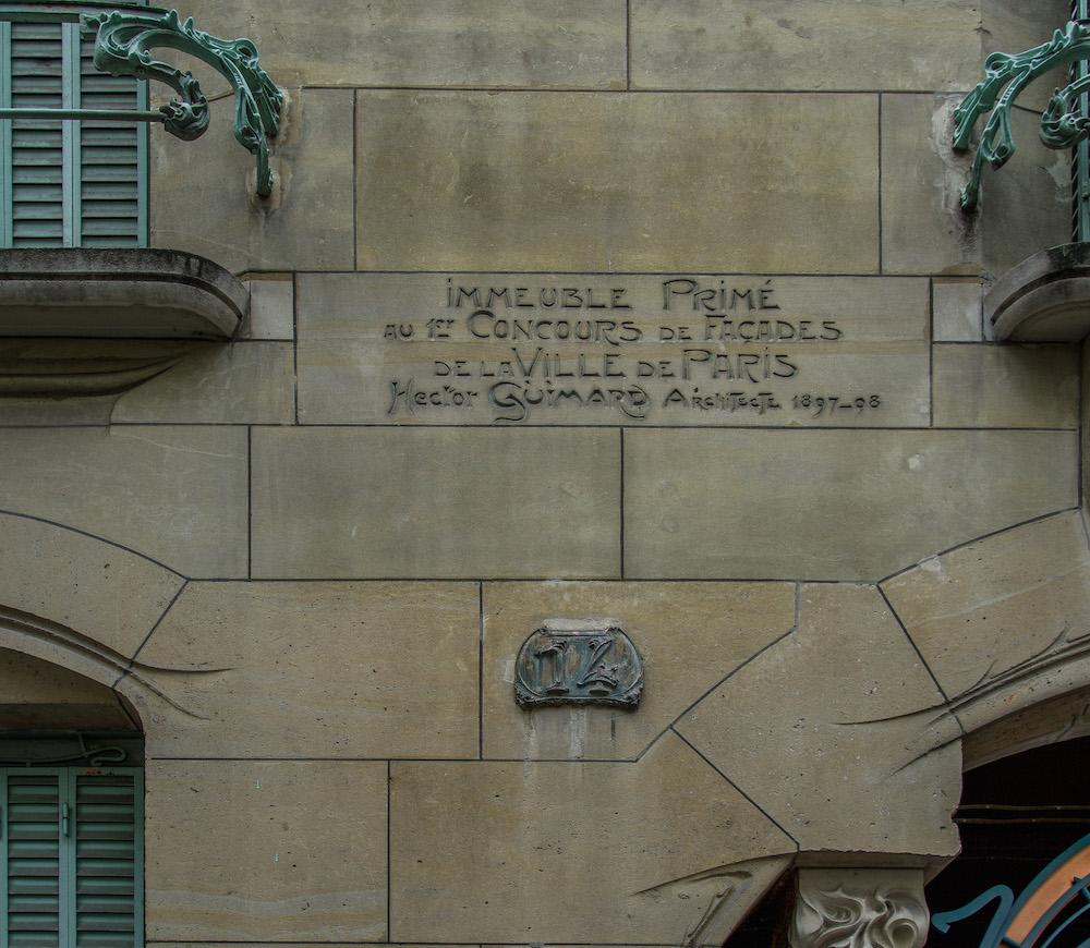 Hector Guimard in Paris 16: Carved in the beige brick is Hector Guimard's signature and the words stating this this building won first prize in the facades contest