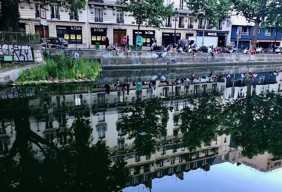 Canal Saint-Martin Paris: the stores and trees are reflected in the canal