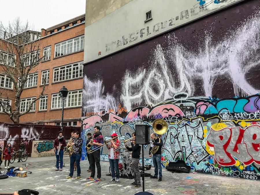 Canal Saint-Martin Paris: street band playing in front of a graffiti wall 