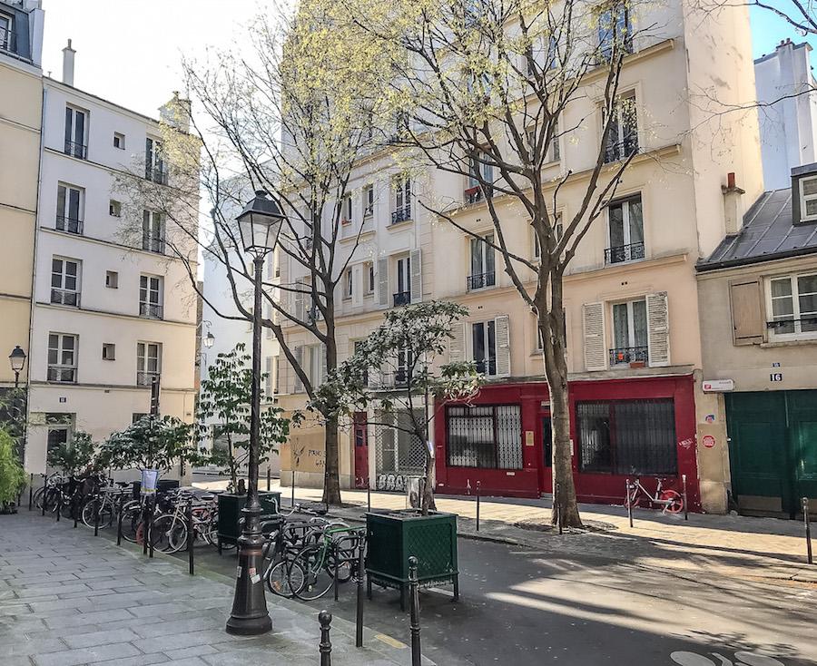 Empty streets in Paris .Red facade and bicycles