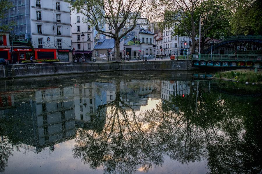 Trees and buildings reflected in the Canal Saint-Martin