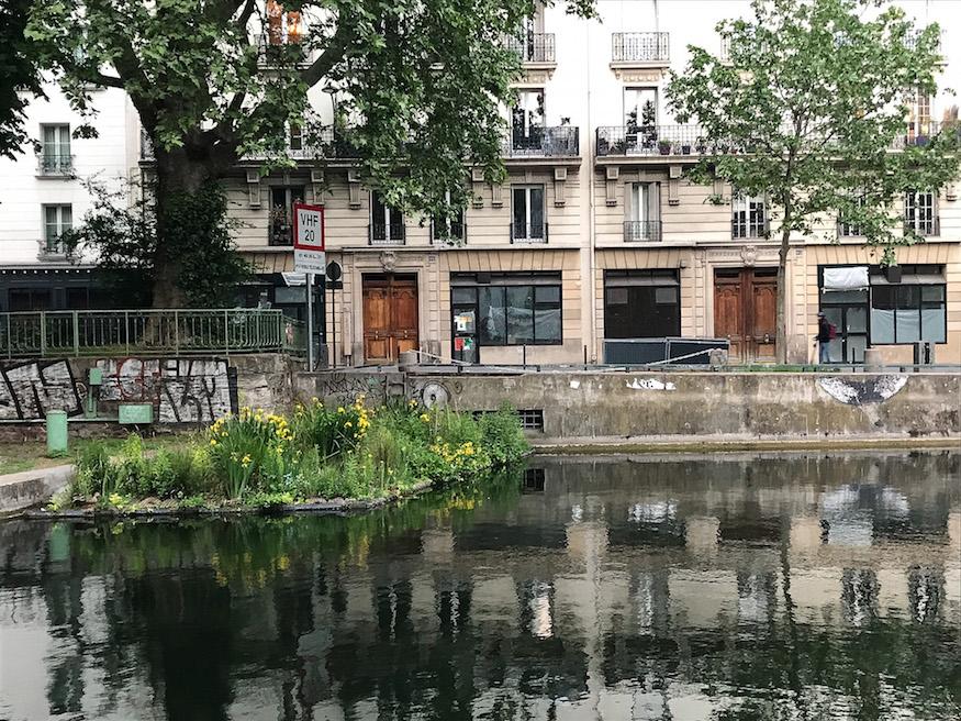 Canal Saint-Martin with yellow daffodils growing in the water