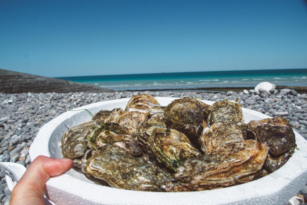 Things to do in Normandy: eat oysters on the beach