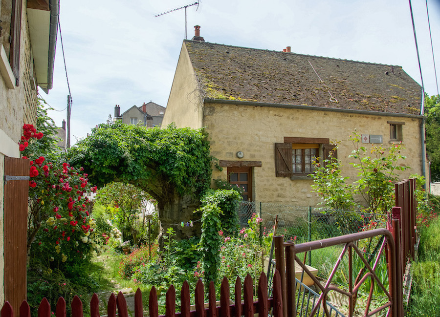 typical home in Auvers-sur-Oise France - stone with shutters and roses