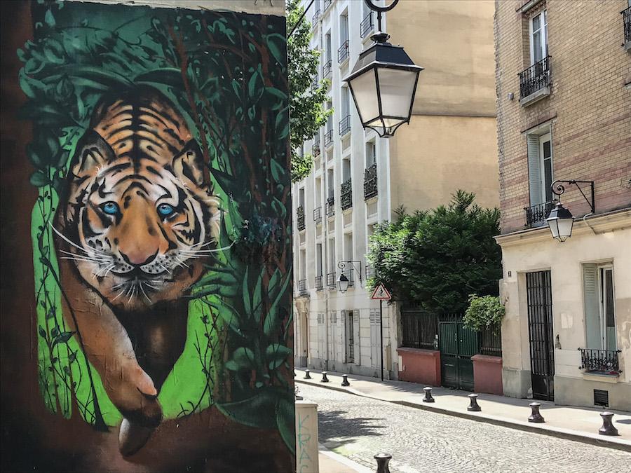Street art - a huge tiger with blue eyes- in La Butte aux Cailles, Paris
