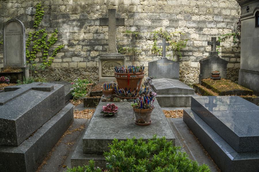 in Montparnasse cemetery teh grave of Marguerite Duras, French writer. Many pens in flower pots on the grave