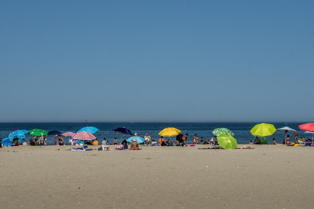 beach umbrellas and people enjoying the beach at Deauville France