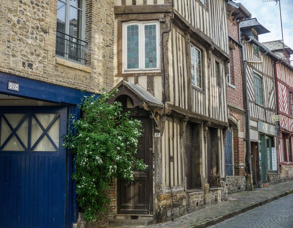brown, red and green half-timbered houses line the streets in Honfleur