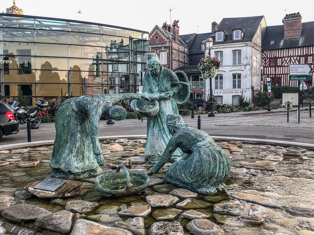 Honfleur France - the mussel pickers statue showing 3 women and their baskets picking mussels