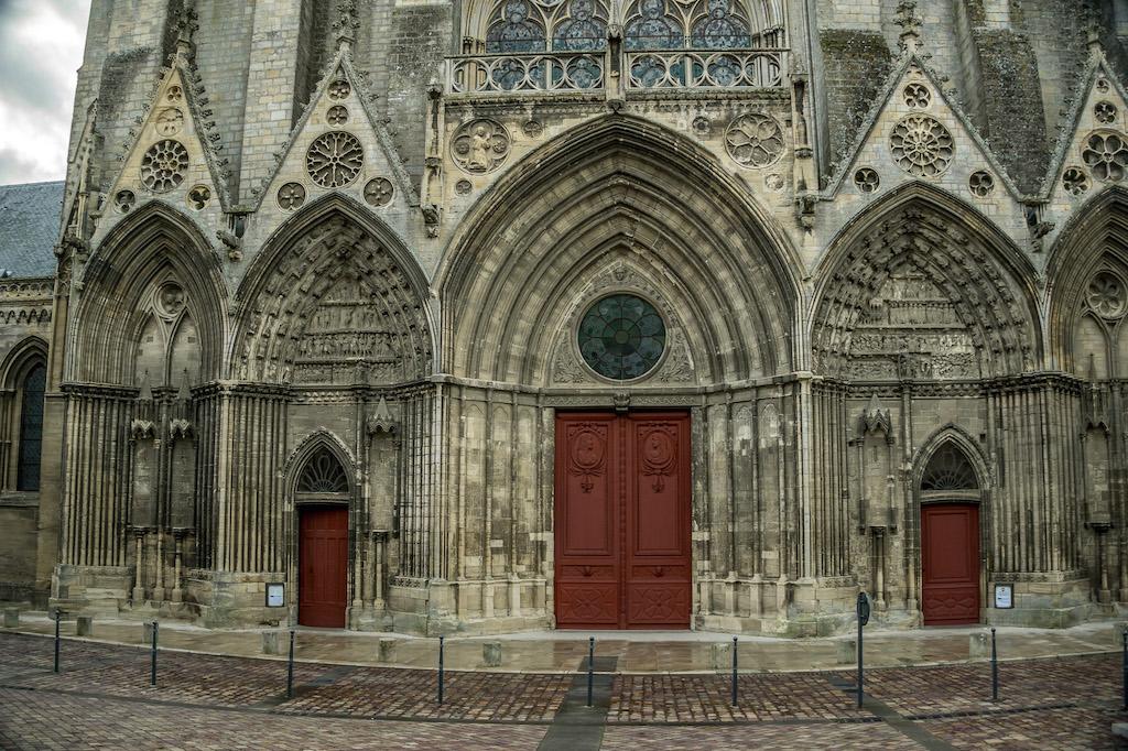 Bayeux France: the 3 red doors  of the cathedral in Bayeux