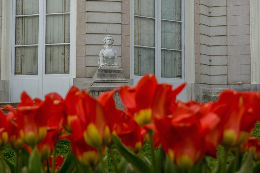 statue at Parc de Bagatelle Paris with red tulips in the foreground